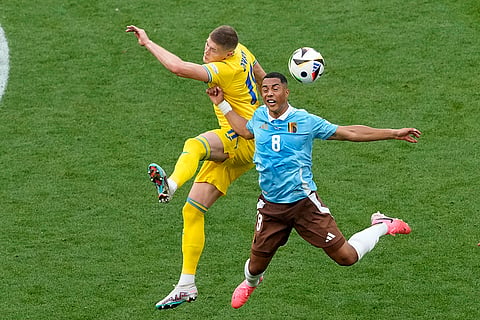 Youri Tielemans goes for the header with Artem Dovbyk